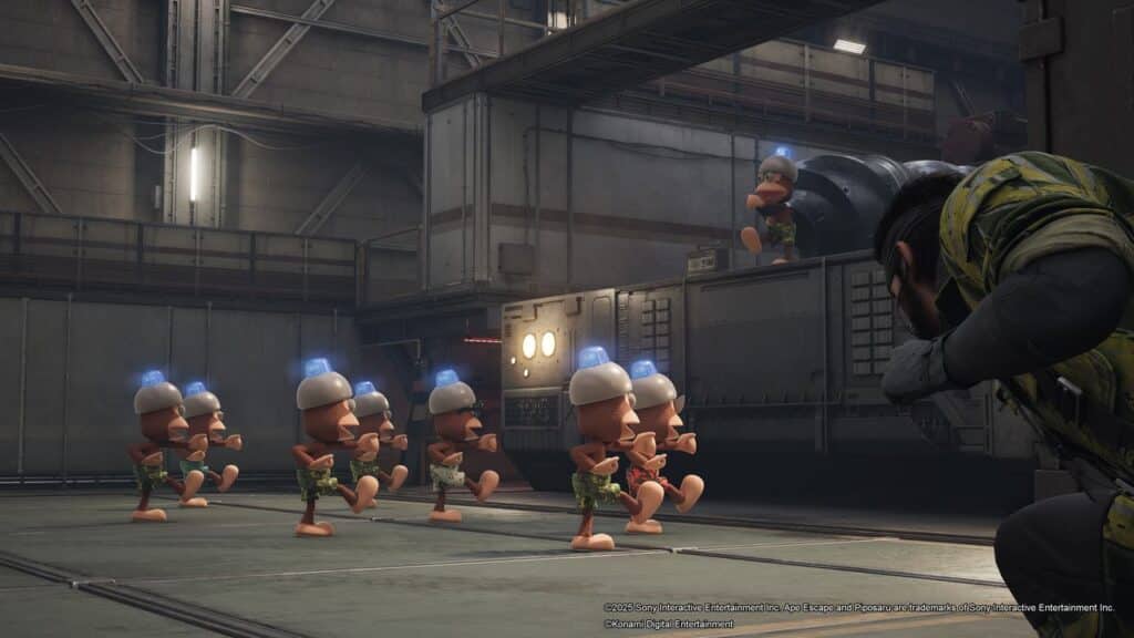 A man hides as a group of small, helmeted cartoon monkeys march inside a large industrial building.
