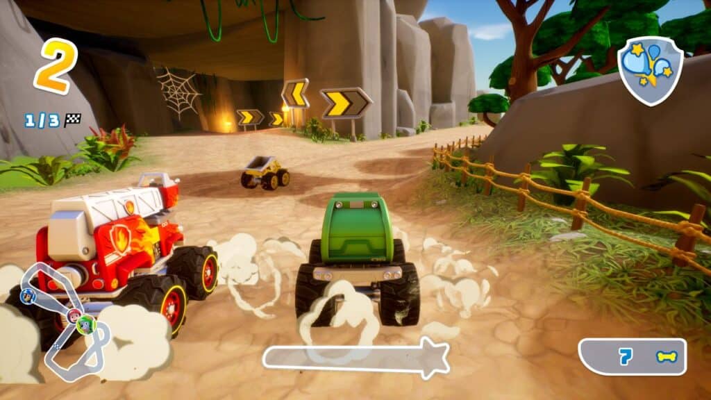 Three cartoon-style cars race on a dirt track with rocks, arrows, and a wooden fence visible, inspired by the excitement of PAW Patrol Rescue Wheels: Championship.