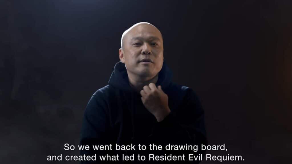 A man in a dark hoodie speaks about creating Resident Evil Requiem, with subtitles, against a dark background.