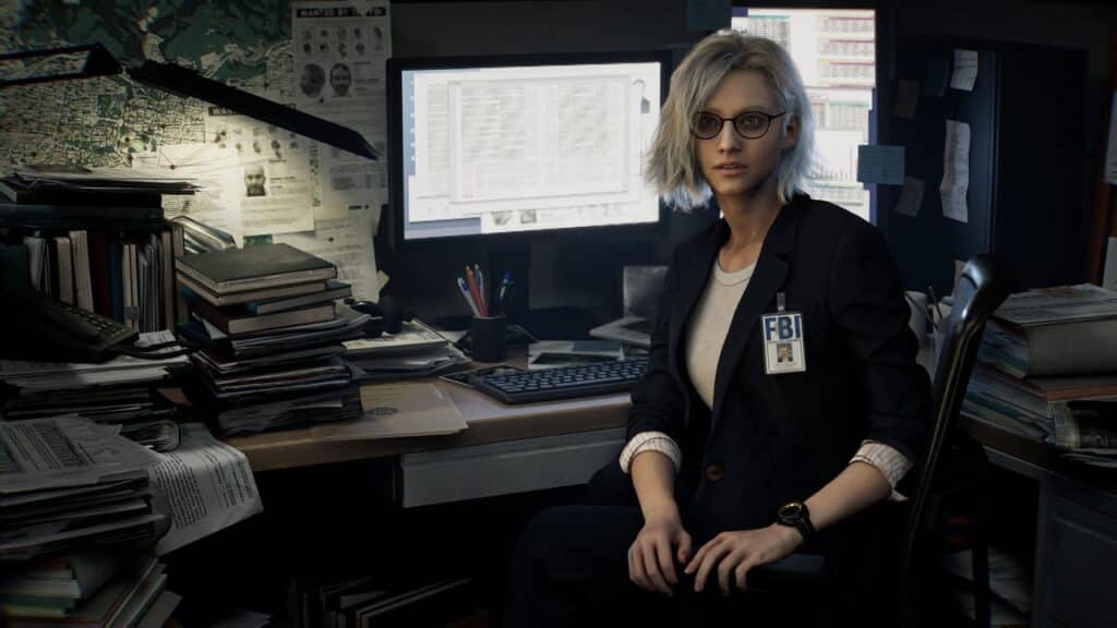A woman with glasses and an FBI badge sits at a cluttered desk with computer monitors and papers, closely examining evidence from the Resident Evil Requiem trailer.