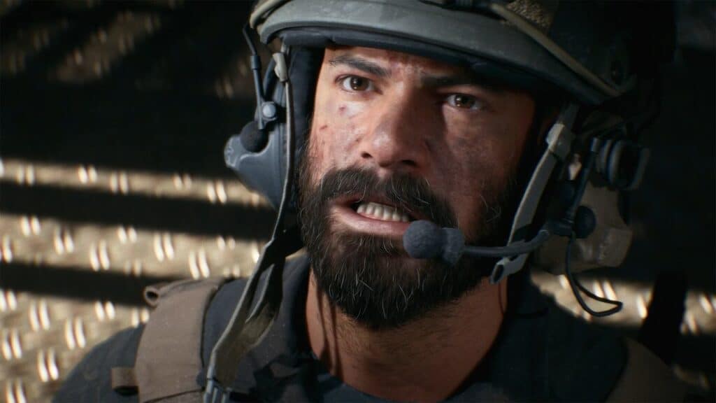 A serious soldier with a beard and helmet speaks into a headset, lit by dim, dramatic lighting, ready for action in Battlefield 6.