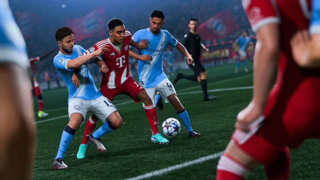 Soccer players in blue and red kits compete for the ball during a tense match on a stadium field in EA Sports FC 26.