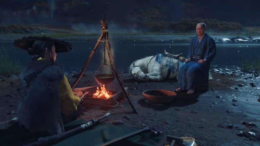Two people sit by a campfire near a river at night, with a horse resting in the background.