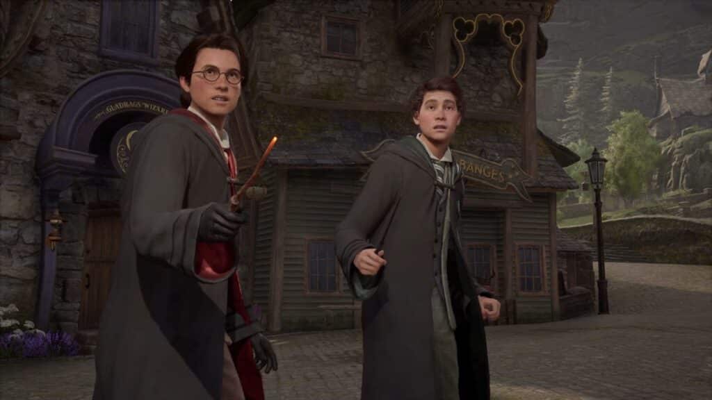 Two people in wizard robes stand outside a medieval-style building, one holding a wand and looking surprised, as if they've stepped straight out of Hogwarts Legacy.