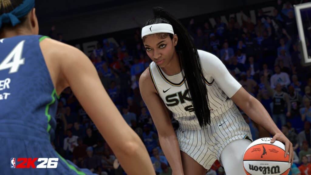 A WNBA player in a white uniform dribbles a basketball, facing off against a defender in NBA 2K26 gameplay.