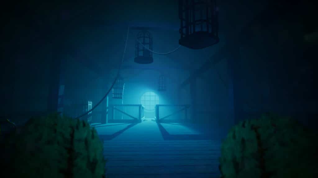 A dimly lit room with cages hanging from the ceiling and blue light shining through a round window in the video game Out of Sight.