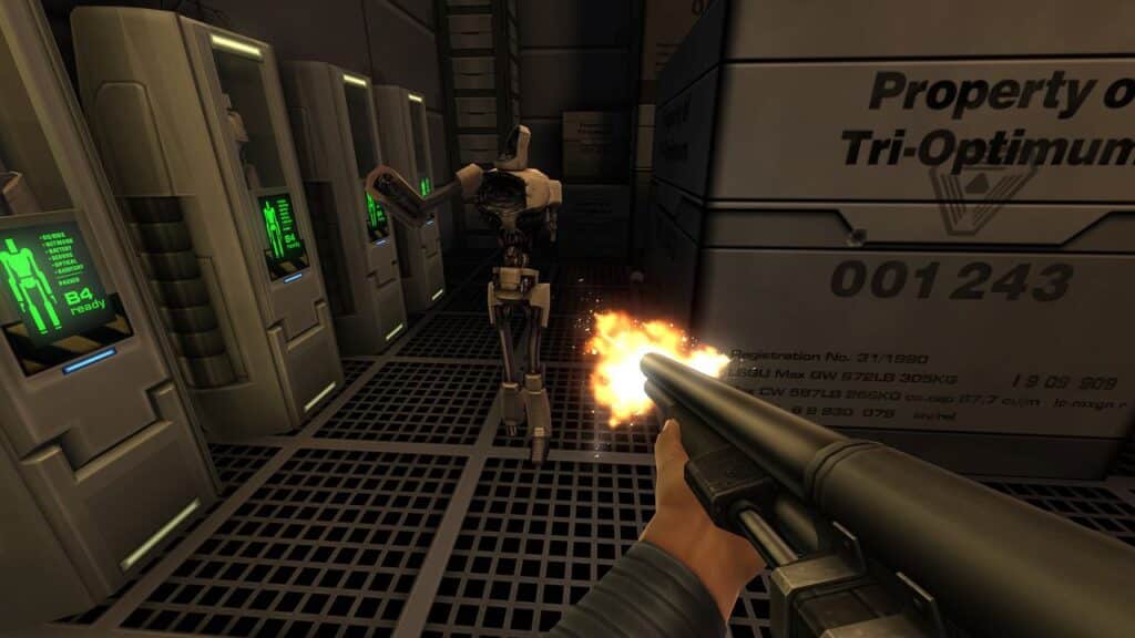 A person fires a shotgun at a humanoid robot inside a futuristic facility with glowing screens and crates, capturing the tense atmosphere reminiscent of the System Shock 2 25th Anniversary Remaster.