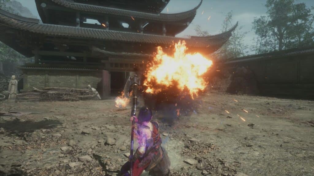 A warrior dodges a fiery explosion outside a traditional Asian-style building in WUCHANG: Fallen Feathers.