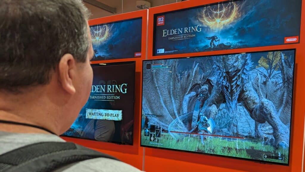 A person watches a screen displaying Elden Ring Tarnished Edition gameplay on Nintendo Switch 2 at Fan Expo Canada 2025.