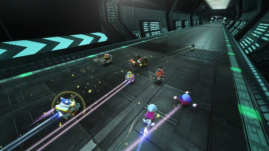 Six colorful characters race in futuristic go-karts on a metallic, neon-lit track inside a tunnel, reminiscent of the high-speed action in Kirby Air Riders.
