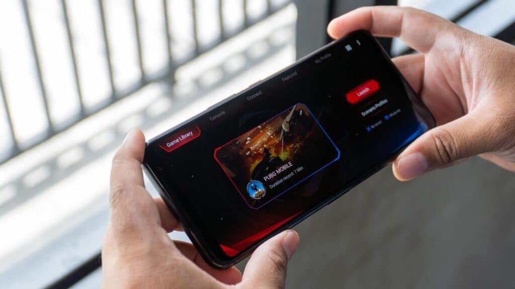 A person holds a smartphone horizontally, enjoying a game in landscape mode near a window—a scene that reflects the growing enthusiasm in the India cloud gaming market.