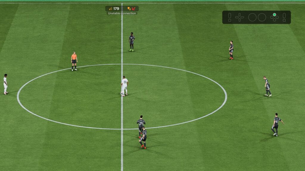 EA Sports FC 26 soccer video game kickoff scene, players on a vivid green field, and a referee in orange at the center circle.