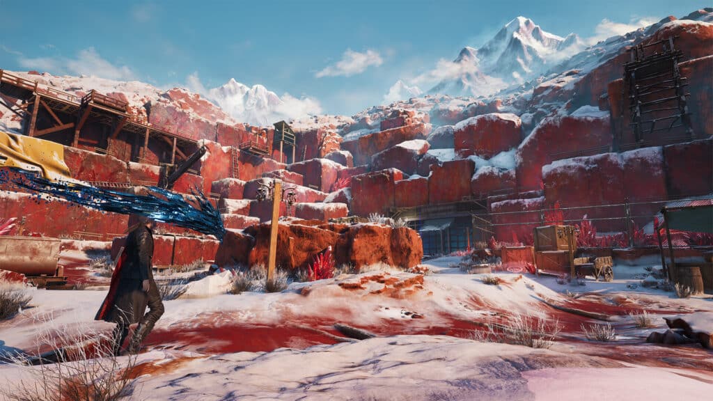 A person with a large blue sword, reminiscent of Lost Soul Aside, walks through a snowy, red rocky canyon under a bright sky with mountains.