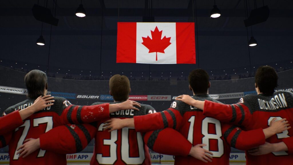Four hockey players in red jerseys stand arm-in-arm, facing a large Canadian flag in an arena in the NHL 26 video game.