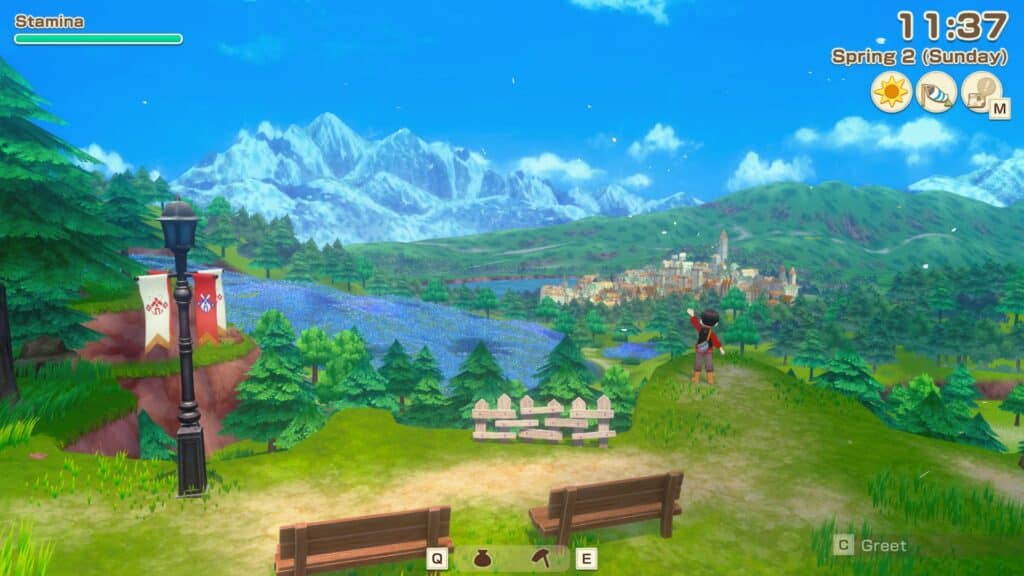 A scenic view of Zephyr Town in _Story of Seasons: Grand Bazaar_, featuring mountains, a river, and lush greenery, with a character standing on a hilltop looking over the town on a sunny day.