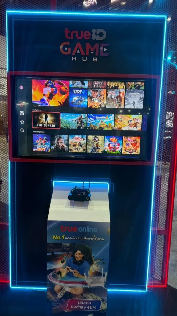 SDK Gaming Hub at the Gamescom Asia x Thailand Game Show 2025 displaying game titles and a controller, branded with "trueID GAME HUB," features the Blacknut Thailand cloud gaming launch for seamless, on-demand play.
