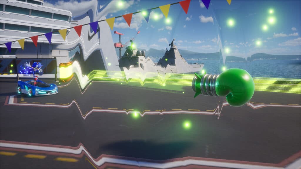 A boxing glove on a spring shoots forward near a blue race car on a ship deck with colorful flags above, evoking the high-speed chaos of Sonic Racing CrossWorlds.
