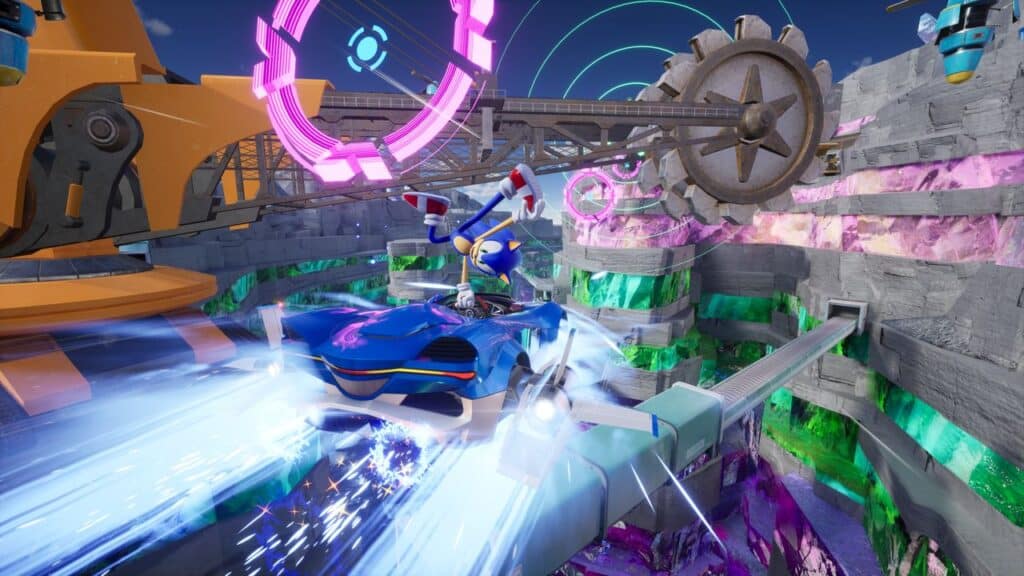 Sonic Racing CrossWorlds puts Sonic behind the wheel of a blue race car on a futuristic track, where neon lights and spinning gears fill the vibrant background.