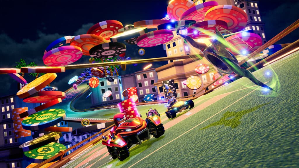 Futuristic race cars from Sonic Racing CrossWorlds speed on a vibrant track with oversized poker chips and neon lights in a city at night.
