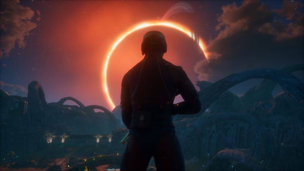 A person in a spacesuit stands on alien terrain, facing a glowing eclipse in a dramatic sky, evoking the cosmic beauty of The Outer Worlds 2.