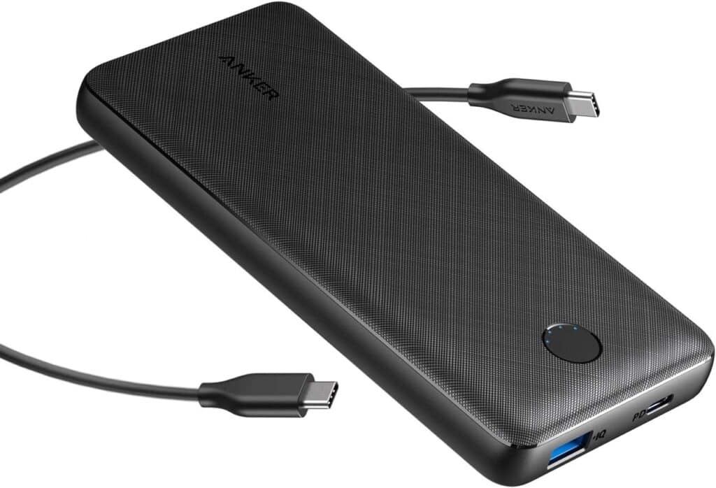 A black Anker portable power bank with a USB-C cable connected and a power button on top—one of the best PlayStation Portal accessories for uninterrupted gaming on the go.