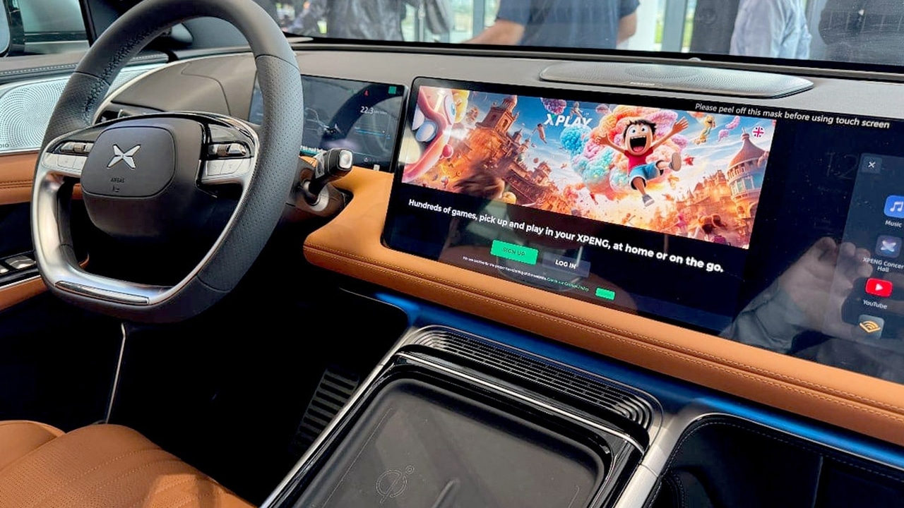 Car interior featuring brown leather seats and a large touchscreen displaying the cloud gaming Xplay XPENG interface.