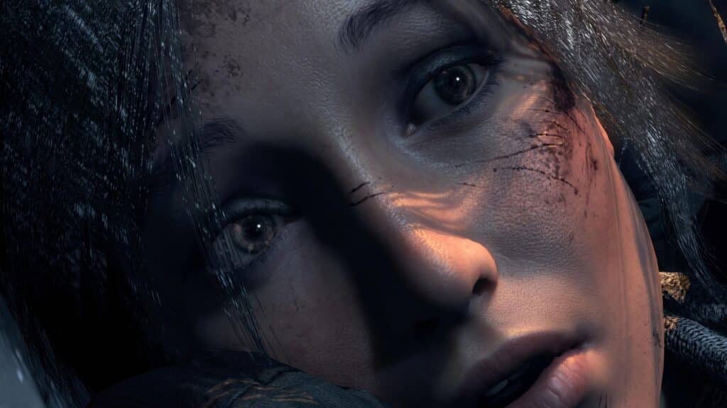 A close-up of a Lara Croft's face with dirt and scratches from Rise of the Tomb Raider, looking upward with a worried expression, as though anticipating the surprises in Amazon Luna free games included with Prime November 2025.