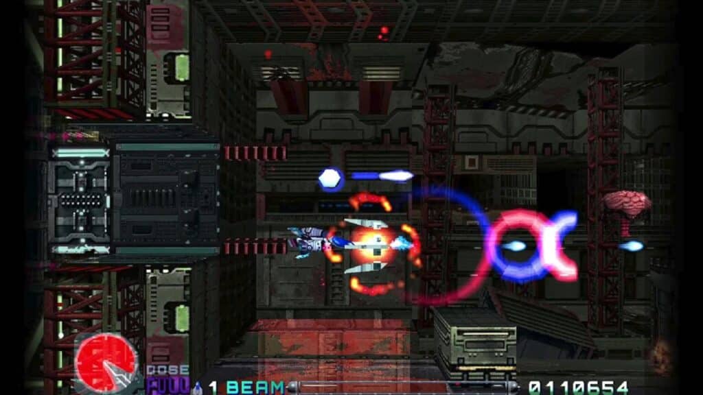 A spacecraft fires beams at an enemy in a side-scrolling sci-fi video game with dark mechanical backgrounds in R-Type Delta: HD Boosted.
