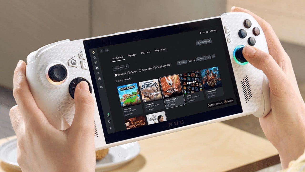 Hands holding a white handheld gaming console displaying a game library screen.
