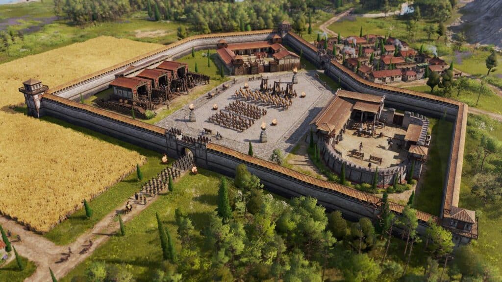 Aerial view of a walled medieval fort from Anno 117: Pax Romana, featuring barracks, training grounds, and a nearby village surrounded by fields.