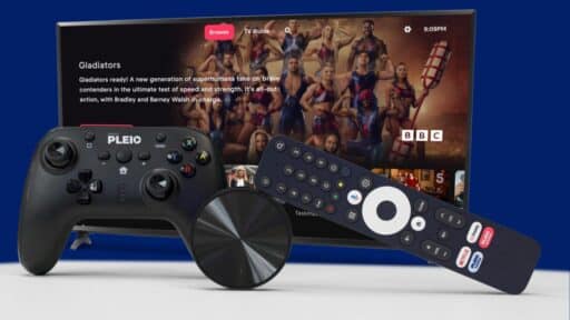 A TV displaying "Gladiators" with a game controller, a smart TV remote, and a streaming device in front—perfect for enjoying PLEIO cloud gaming.
