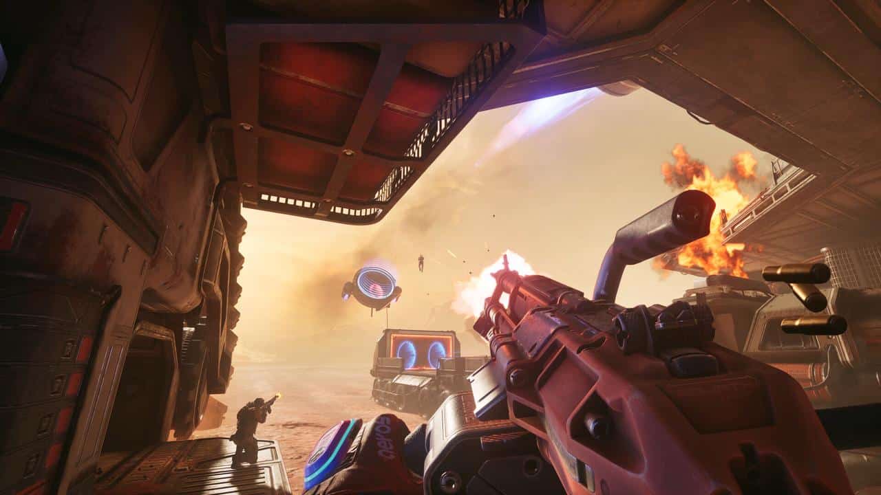 First-person view of a futuristic gun firing at flying drones in a sci-fi desert arena, with explosions reminiscent of Splitgate: Arena Reloaded.