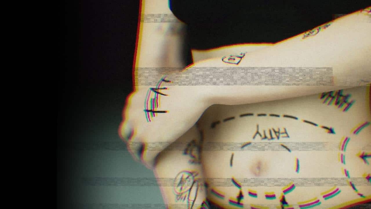 A scene from BrokenLore: UNFOLLOW showing a person with drawn lines, arrows, and the word "fatty" on their stomach and arms, wearing a black top.