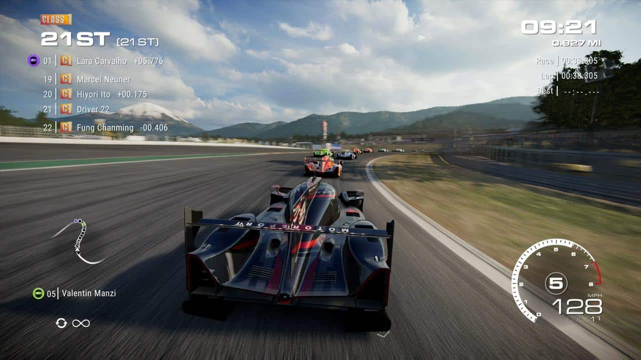 A racing video game, GRID Legends: Deluxe Edition, displays a car in 21st place speeding on a track with other cars ahead and stats on screen.
