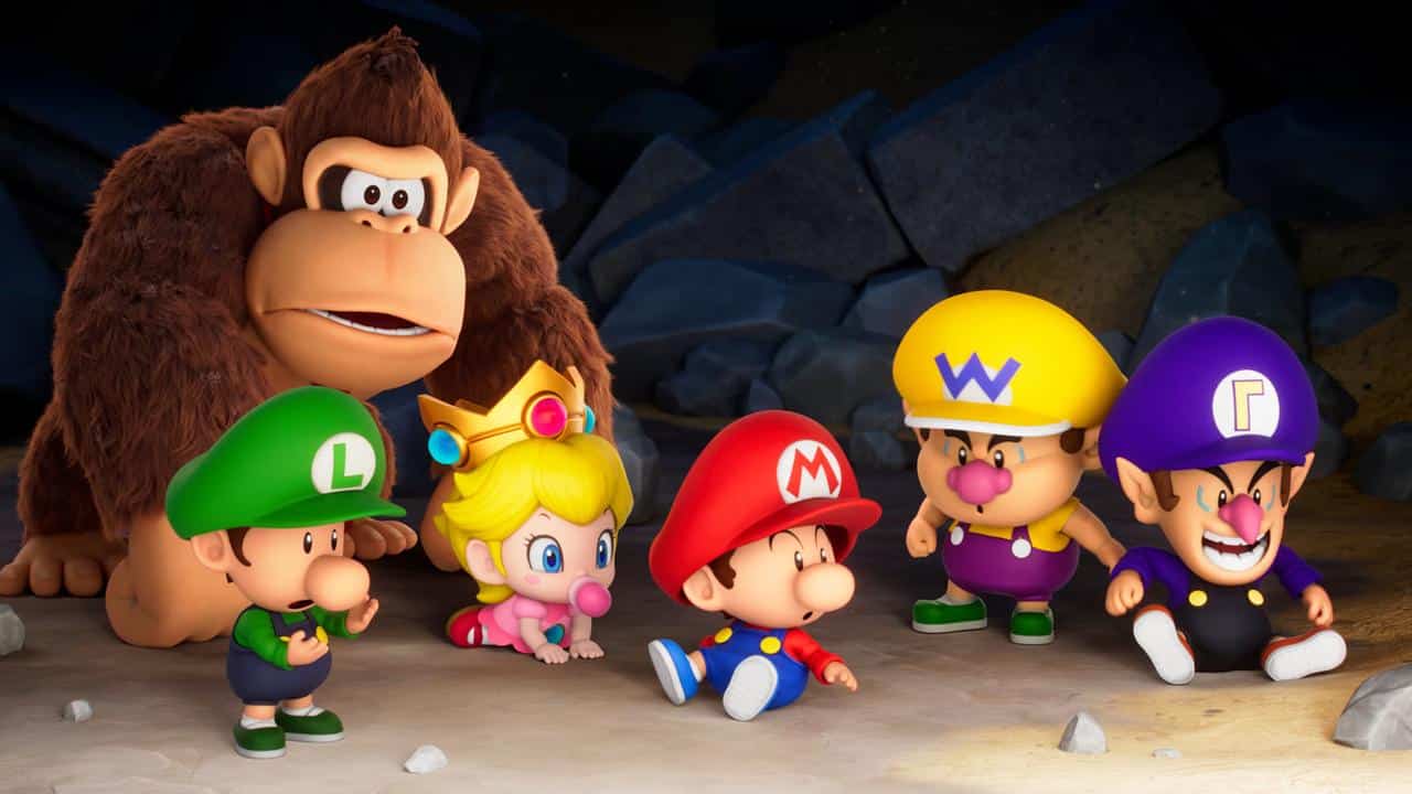 Baby versions of Donkey Kong, Peach, Mario, Luigi, Wario, and Waluigi sit together in a cave, dreaming up their next Mario Tennis Fever adventure.