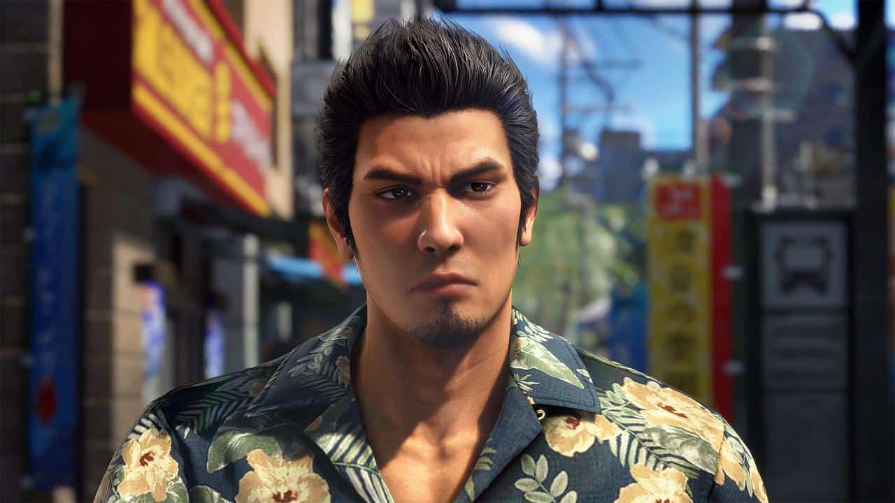 Kiryu with styled hair and a floral shirt stands on a city street with colorful signs behind him, evoking the bold energy of Yakuza Kiwami 3 and hinting at dark ties to the bustling nightlife.
