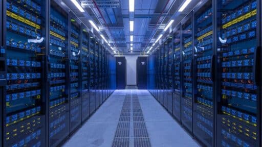 Rows of GPU servers inside a blue-lit data centre representing GPU-as-a-Service capacity for cloud gaming.