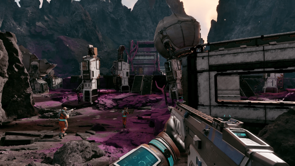 A futuristic landscape with rocky terrain and pink ground, featuring abandoned structures and a character holding a weapon in the foreground.
