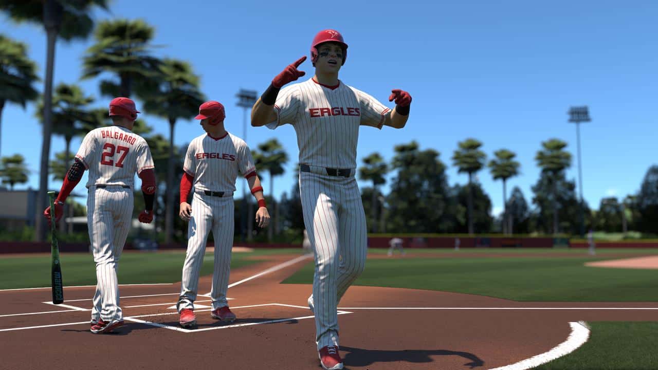 A player celebrating at home plate after a home run during the high school years in MLB The Show 26 Road to the Show.