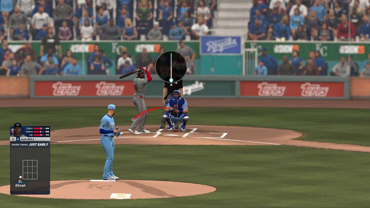 A pitcher in blue throws to a batter in gray during an MLB The Show 26 baseball video game, stadium full of fans.