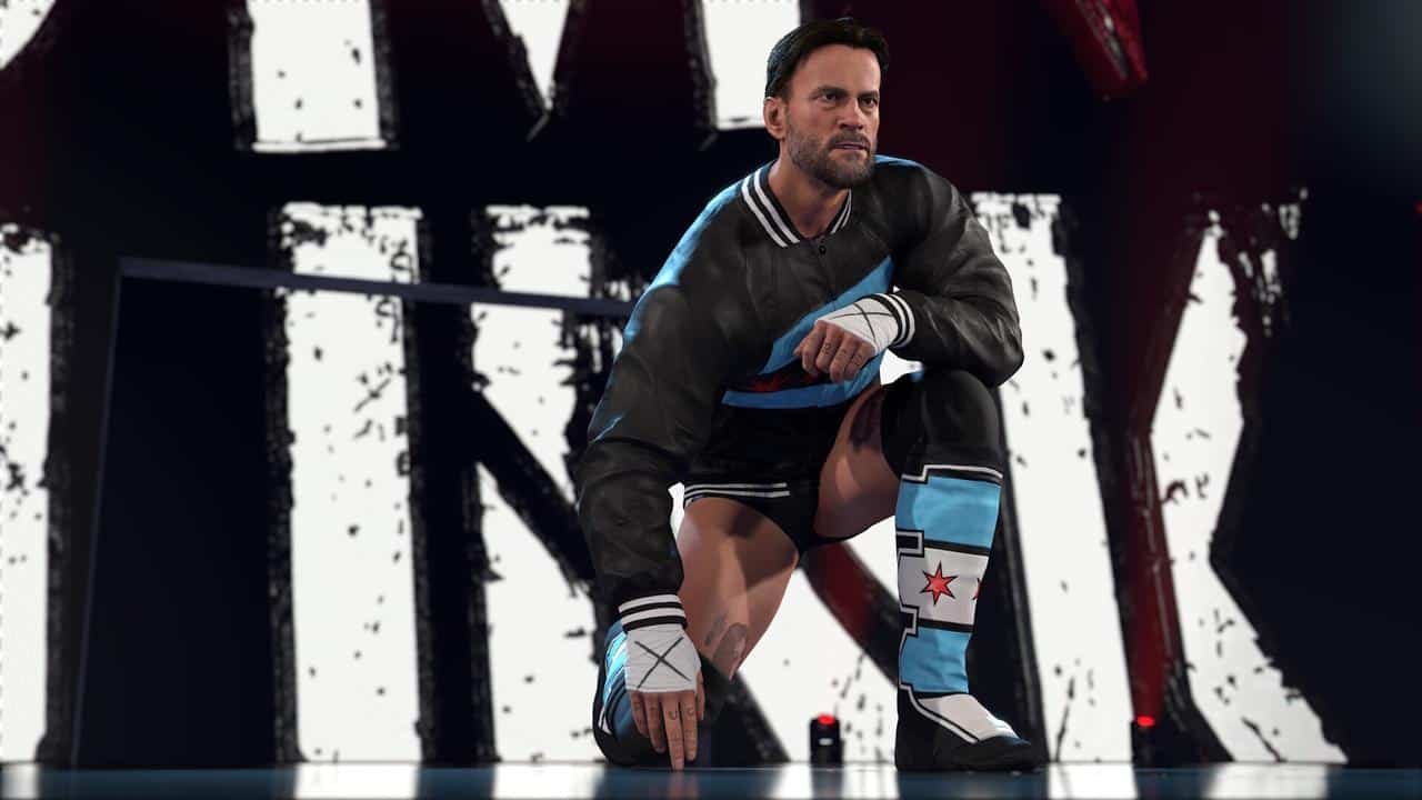 CM Punk kneels on stage with bold letters in the background, capturing the intense atmosphere of WWE 2K26.