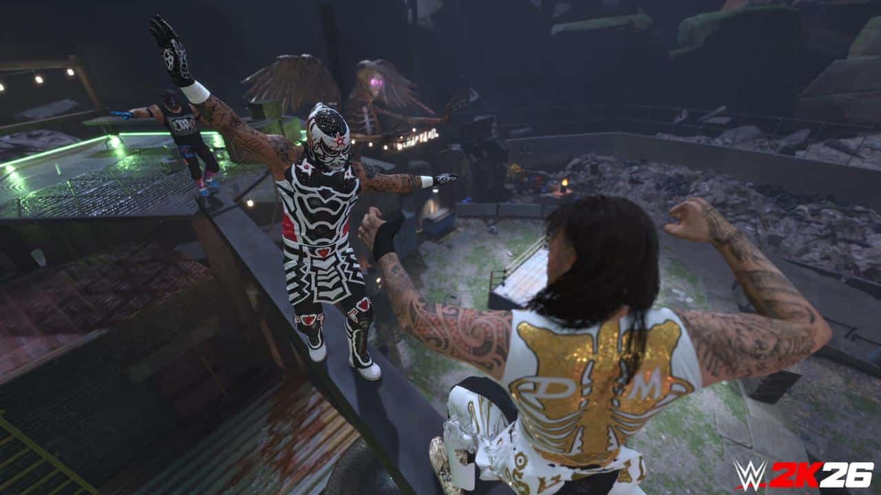 Two masked wrestlers face off on a high platform in WWE 2K26, with dramatic lighting and rubble below.