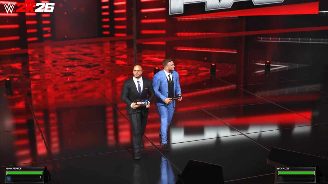 Two men in suits walk on a red-lit stage in WWE 2K26, each holding a microphone as they prepare to address the virtual audience.