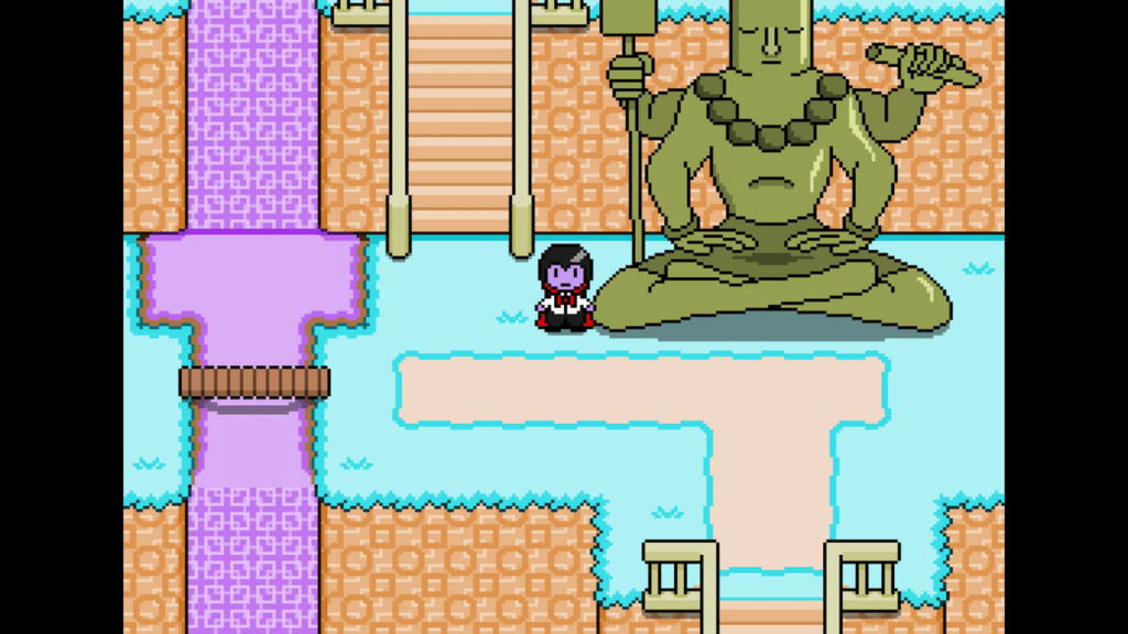 A character in a video game standing in front of a large, seated statue holding a staff, surrounded by a colorful landscape with water and walkways.