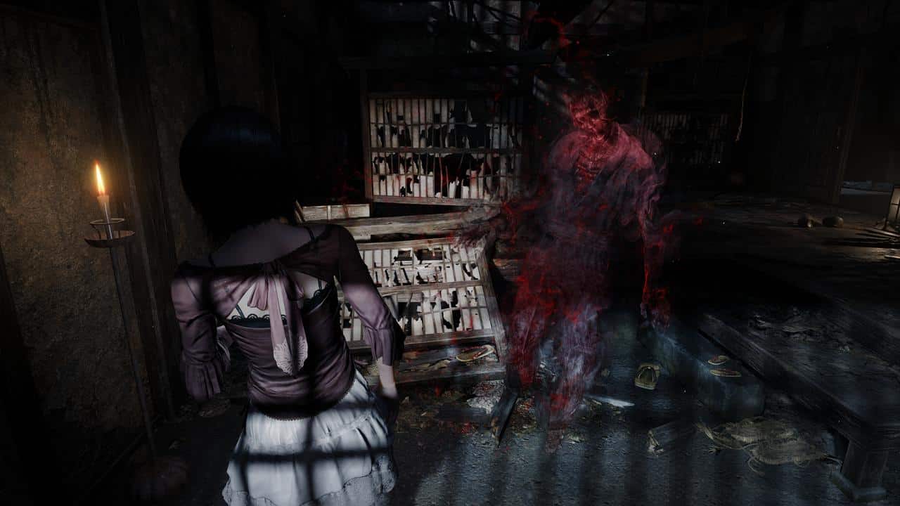 A girl faces a ghostly red figure in a dark, cluttered room lit by candlelight, echoing the haunting atmosphere of FATAL FRAME II: Crimson Butterfly REMAKE.