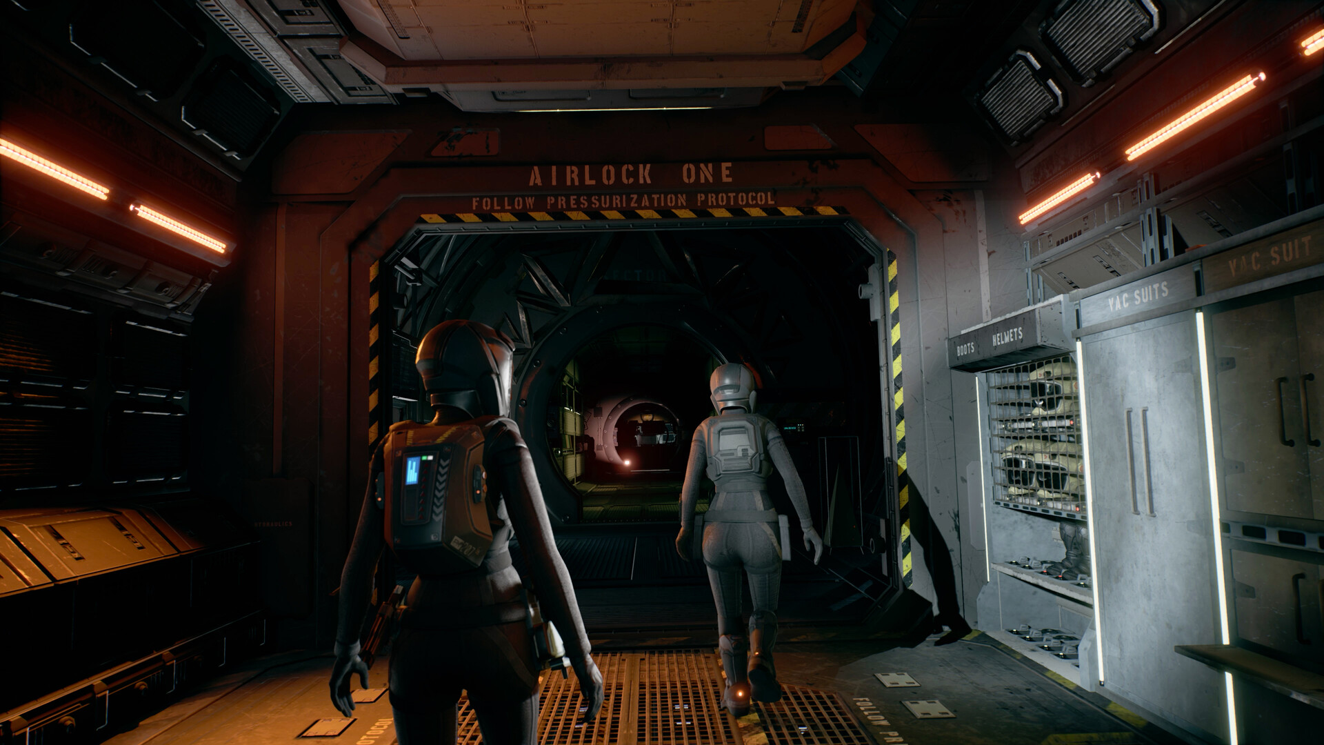 Camina Drummer and a crew member in vacuum suits prepare to exit the Artemis airlock in a scene from The Expanse: A Telltale Series.