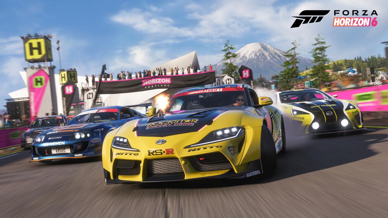 Three Formula Drift racing cars sliding through a festival corner with smoke and Mount Fuji in the background in Forza Horizon 6.