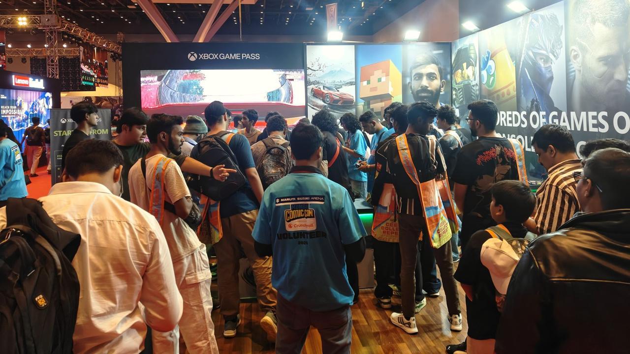 A dense crowd of gamers gathered around the Xbox Game Pass booth at Mumbai Comic Con 2026, with banners for Cricket 24 and Minecraft visible in the background.