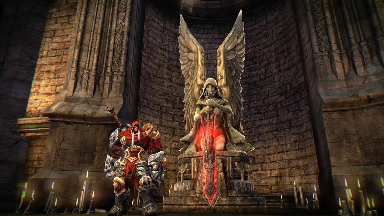 War stands beside a winged statue inside a dungeon in Darksiders Warmastered Edition.