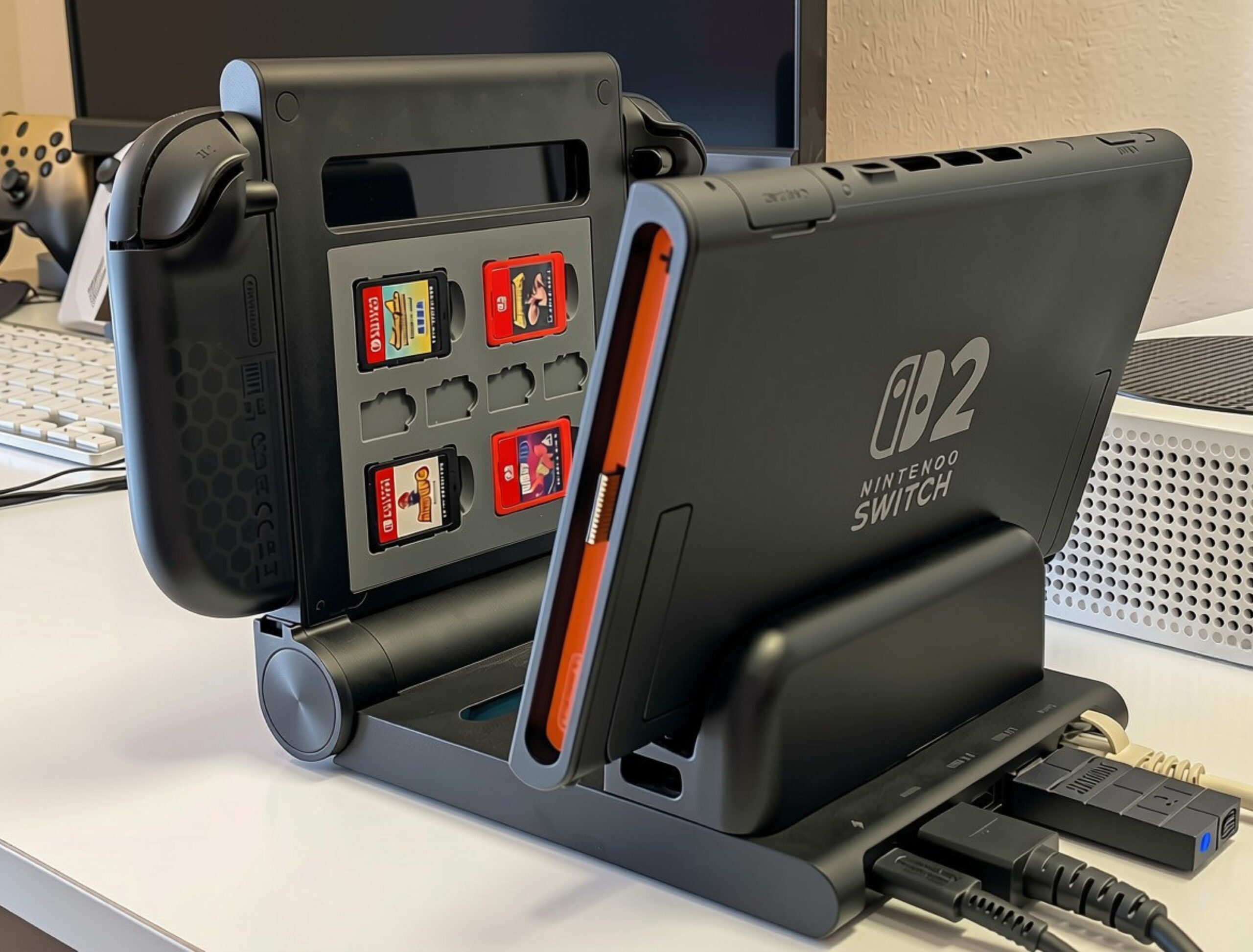 Disseny sense títol - 3 Nintendo Switch OLED model with game card holder and connected accessories on a desk